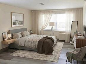 Hyannis apartment for rent - A bedroom with a large bed, a chair, and a nightstand.