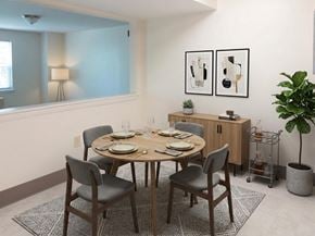 Hyannis apartment for rent - A dining room with a round table set for six.