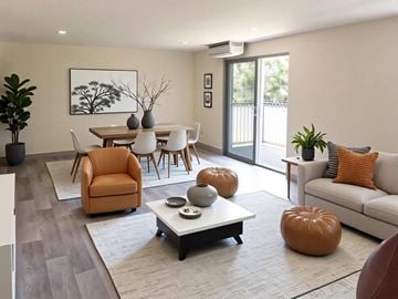Hyannis apartment for rent - A living room with a brown chair and a white table.