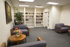 Chicago apartment for rent - a waiting room in a library with chairs and a table with flowers