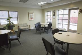 Chicago apartment for rent - a common area with tables and chairs and windows