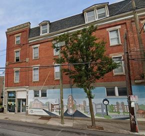 Cincinnati apartment for rent - a red brick building with a mural on the side of it