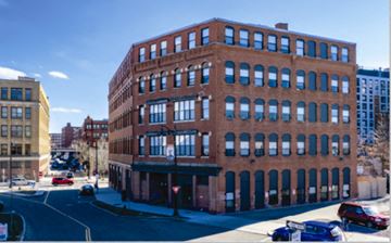 Lynn apartment for rent - A red brick building with a parking lot in front.