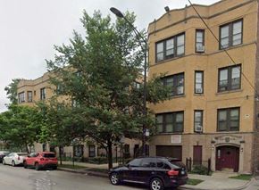 Chicago apartment for rent - a black car is parked in front of a building