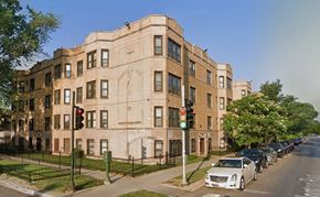 Chicago apartment for rent - a building on the corner of a street with cars parked in front of it