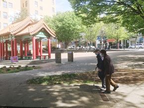 Seattle apartment for rent - two people walking down a sidewalk on a city street