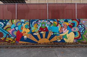 Seattle apartment for rent - A mural of people sitting around a table is painted on a wall.