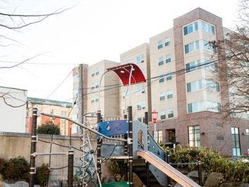Seattle apartment for rent - a playground in front of a large building