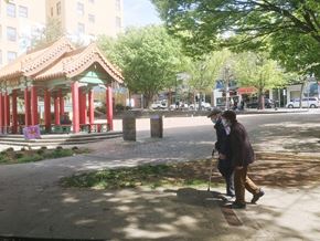 Seattle apartment for rent - two people walking down a sidewalk on a city street