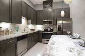 Houston apartment for rent - Luxury apartments with spacious kitchens with granite countertops, large granite slab island, built-in wine rack, and stainless appliances at Le Palais Apartments in Houston.