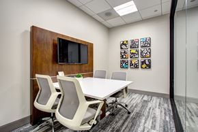 Chicago apartment for rent - a conference room with a white table and chairs and a television