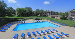 Lincoln apartment for rent - Huge swimming pool with spacious sundeck, poolside lounge chairs, beautiful landscaping, scenic views, lots of trees at LionsGate Apartments in Lincoln, Nebraska