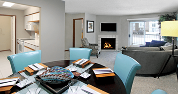 Omaha apartment for rent - a living room with a table with chairs and a fireplace