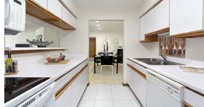 Lincoln apartment for rent - Bright white kitchen with lots of cabinet space, lots of counter space, and spacious dining room at at LionsGate Apartments in Lincoln, Nebraska