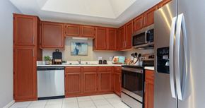 Dallas apartment for rent - Spacious kitchen with stainless steel appliances, side-by-side refrigerator with water dispenser, recessed ceiling, and lots of cabinet space at The Dorchester Apartments in Dallas Texas