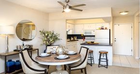 Omaha apartment for rent - Apartments with open floor plan, spacious layout, colored feature wall, kitchen island, and prep island at Embassy Park Apartments in Omaha, Nebraska