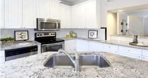 Houston apartment for rent - Spacious kitchen with island, granite countertops, custom home cabinets, French doors, smooth glass top stove, spacious pantries, breakfast bar and stainless-steel appliances at Tuscany Row Townhomes in Houston.