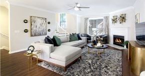 Houston apartment for rent - Spacious living room with wood plank flooring and wood-burning fireplace at Tuscany Villas Townhomes in Houston.