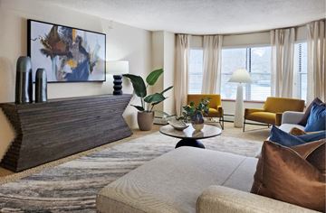 Minnetonka apartment for rent - A living room with a large painting on the wall and a rug on the floor.