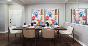 Lincoln apartment for rent - Luxury apartments with spacious dining room, mirror accent wall, and wood grain plank floors at Lenox Village Apartments in Lincoln, Nebraska