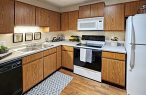 Minnetonka apartment for rent - Kitchen with honey brown toned cabinets and lots of cabinet space at Claremont Apartments in Minnetonka, Minnesota