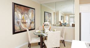 Lincoln apartment for rent - Luxury apartments with spacious dining room and mirror accent wall at Rockledge Oaks Apartments in Lincoln, Nebraska