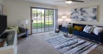 Lincoln apartment for rent - a living room with a blue couch and a sliding glass door