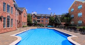 West Des Moines apartment for rent - Luxury apartments with red brick exterior, huge swimming pool, poolside lounge chairs, and lush landscaping at TurtleCreek apartments in West Des Moines, Iowa