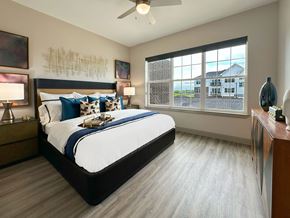 Lincoln apartment for rent - A bedroom with a large bed and a ceiling fan.