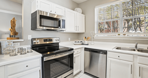 Dallas apartment for rent - Luxury apartments with kitchens with white cabinets and stainless-steel appliances at The Saxony Apartments in Dallas