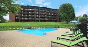 Omaha apartment for rent - Resort-style saltwater pool with huge sun deck, poolside lounge chairs, and park-like setting with lots of trees and scenic views at Embassy Park Apartments in Omaha, Nebraska