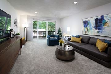 Omaha apartment for rent - A living room with a brown couch and a painting on the wall.