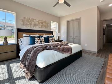 Lincoln apartment for rent - A bedroom with a large bed and a ceiling fan.