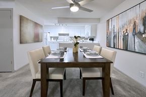 Omaha apartment for rent - A dining room with a table set for two and a painting on the wall.