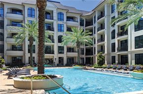 Houston apartment for rent - Luxury apartments with resort-style pool with palm trees, Baja shelf, fountains, lap lane, outdoor lounges, and grilling station at Le Palais Apartments in Houston.