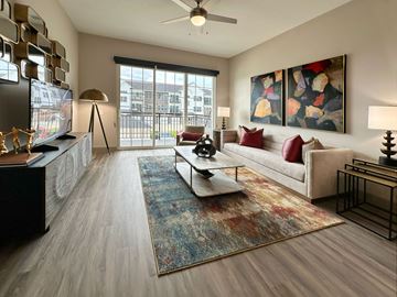 Lincoln apartment for rent - A living room with a couch, a coffee table, and a painting on the wall.