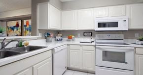Dallas apartment for rent - Bright white kitchen with tile floors at Preston Village Apartments in north Dallas