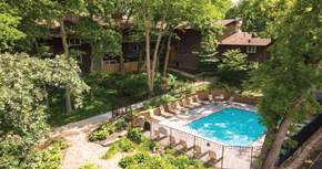 Omaha apartment for rent - a backyard with a swimming pool and a house with trees