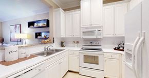 Minnetonka apartment for rent - Luxury apartments with white cabinets, bright white kitchens, granite breakfast bar, and side-by-side refrigerator at RidgeGate Apartments in Minnetonka, Minnesota