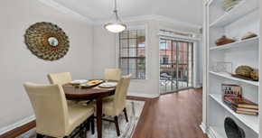 Houston apartment for rent - Spacious dining room with built-in bookshelves, hardwood floors, and French doors at Tuscany Villas Apartments in Houston.