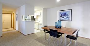 Lincoln apartment for rent - Spacious dining room area and kitchen with tiled floor, white cabinets, and lots of cabinet space at Tanglewood Apartments in Lincoln Nebraska