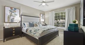 Houston apartment for rent - Spacious master bedroom with attached master bathroom, spacious walk-in closet and grey colored walls at Village on the Parkway Apartments in Houston, Texas