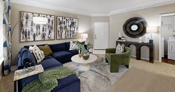 Houston apartment for rent - A living room with a blue couch and a green armchair.