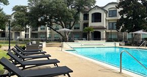 Houston apartment for rent - Luxury resort-style swimming pool with fountain, poolside lounges chairs, beautiful landscaping, lush landscaping and scenic views at Village on the Parkway Apartments.