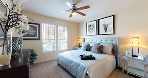 Houston apartment for rent - Spacious master bedroom with attached master bathroom, walk-in closet, and ceiling fan at The Voss Apartments in Houston.