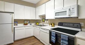 Houston apartment for rent - A kitchen with white cabinets and appliances.