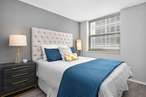 Chicago apartment for rent - a bedroom with a large bed and a window