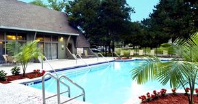 La Vista apartment for rent - Large swimming pool with poolside lounge chairs, beautiful landscaping, park-like setting, scenic views, and luxury resident clubhouse at Alpine Village Apartments in La Vista, Nebraska