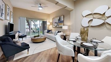 Irving apartment for rent - A modern living room with a glass table and white chairs.
