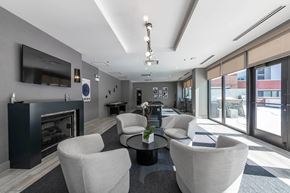 Chicago apartment for rent - A modern living room with a fireplace and a flat screen TV.